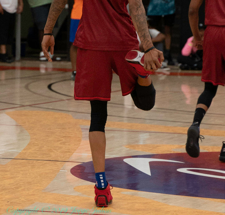 Basketball player wiping dust and dirt off their shoes