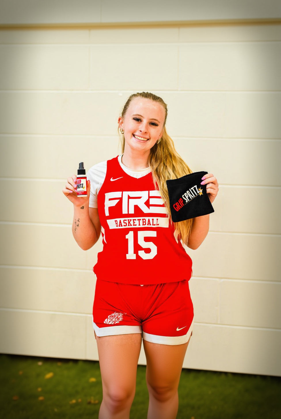 Girls basketball player using Grip spritz for better court traction