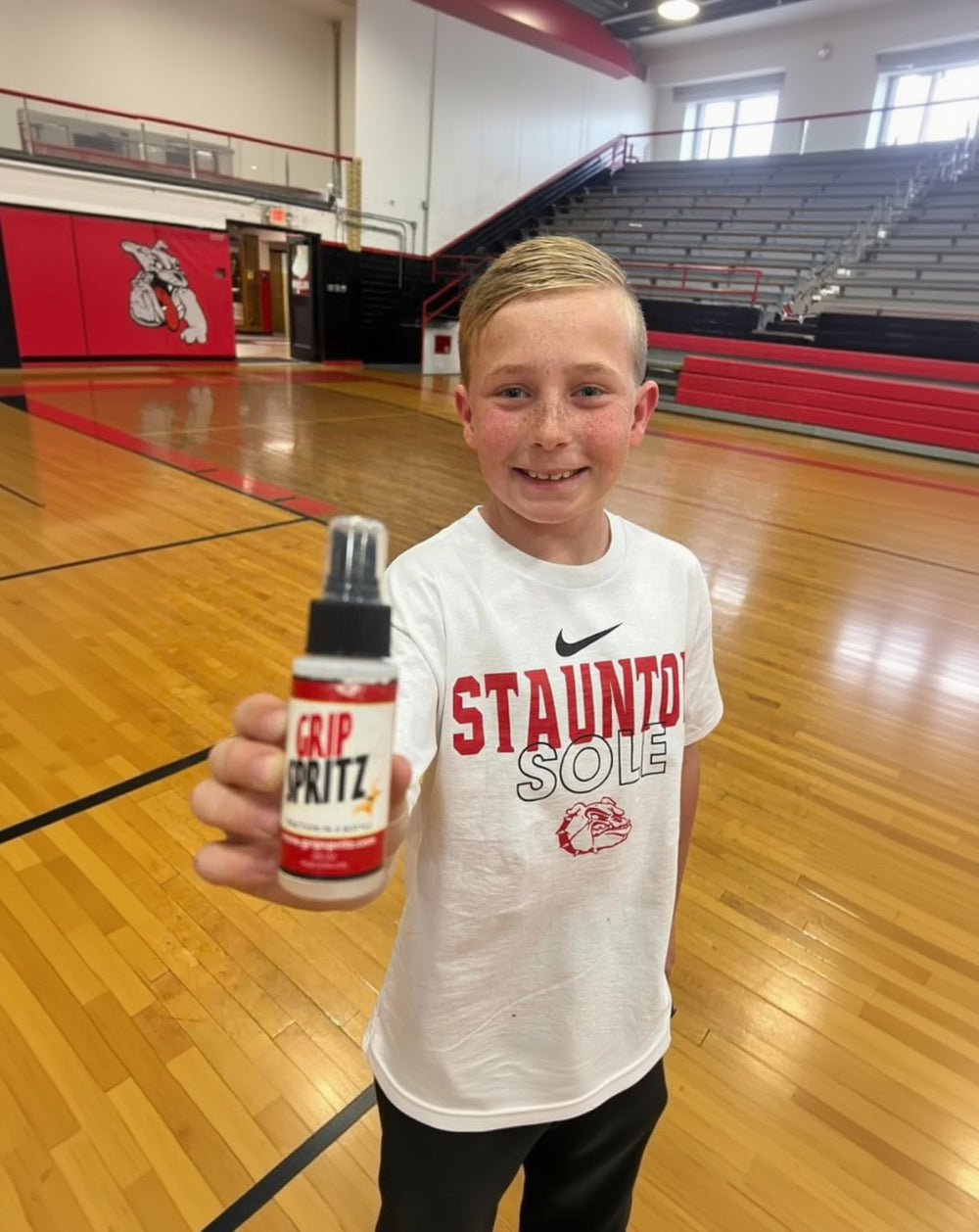 Basketball player showing off his Grip Spritz basketball shoe grip spray