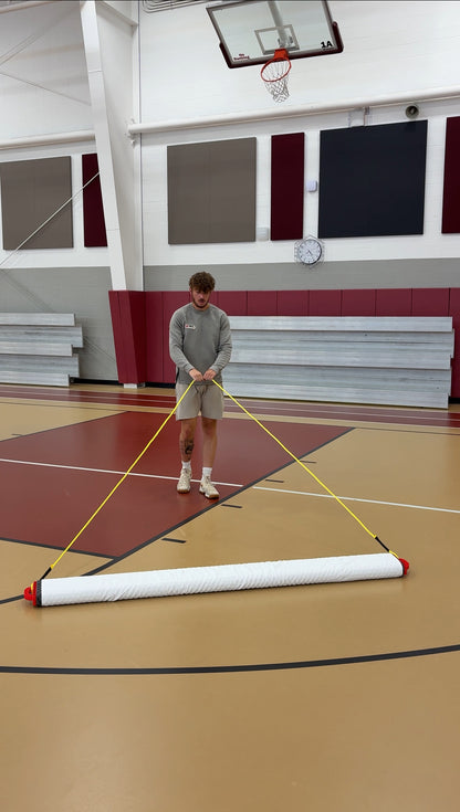 Person cleaning a basketball court with the grip spritz wet mop system